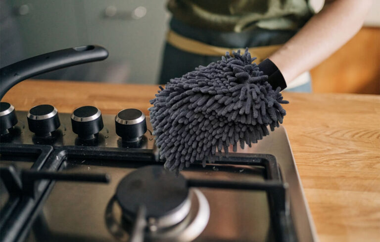 A person wrapping their hand with a Kitchen Cleaning Cloth.